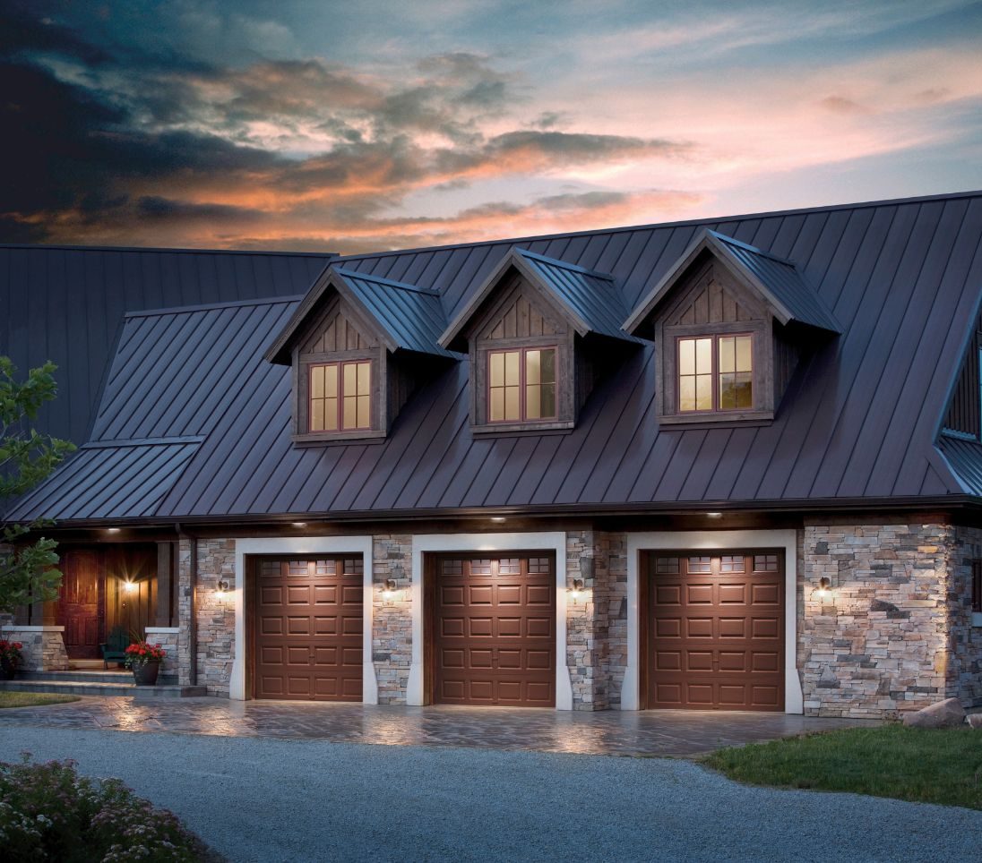 Brown carriage garage doors at dusk